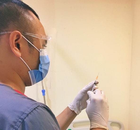 medical assistant with syringe